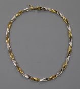 An 18ct two colour gold stepped link necklace, 27.4 grams.