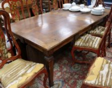 An extending oak dining table W.98cm