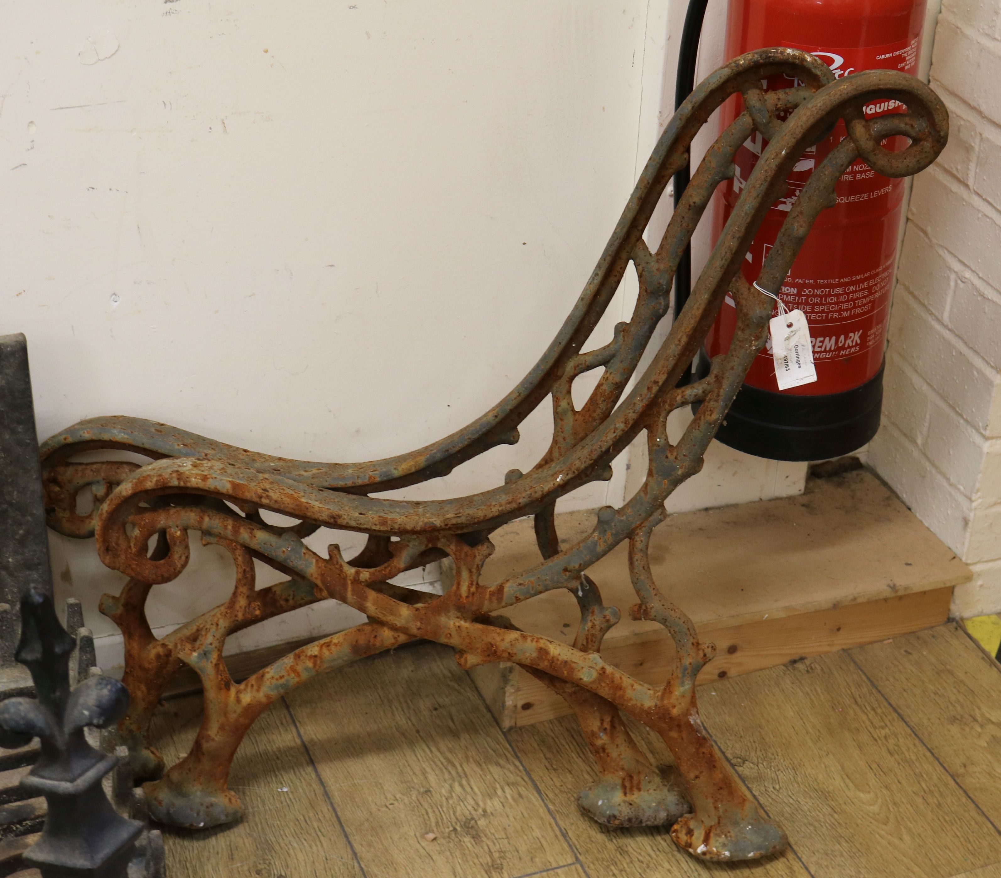 A pair of Victorian cast iron bench ends of rustic wood design W.65cm