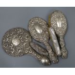 Five assorted repousse silver mounted brushes, mirror etc.