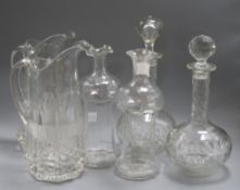 A pair of glass jugs, a pairs of decanters and a pair of decanters (missing stoppers)