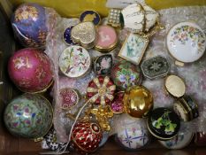 A collection of enamelled patch and trinket boxes, including two Faberge style egg paste-set