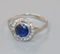 A 1920's platinum, sapphire and diamond cluster target ring, size L.