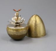 A silver-gilt 'surprise' egg by Stuart Devlin, opening to reveal an enamelled butterfly resting on a