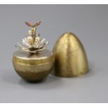 A silver-gilt 'surprise' egg by Stuart Devlin, opening to reveal an enamelled butterfly resting on a