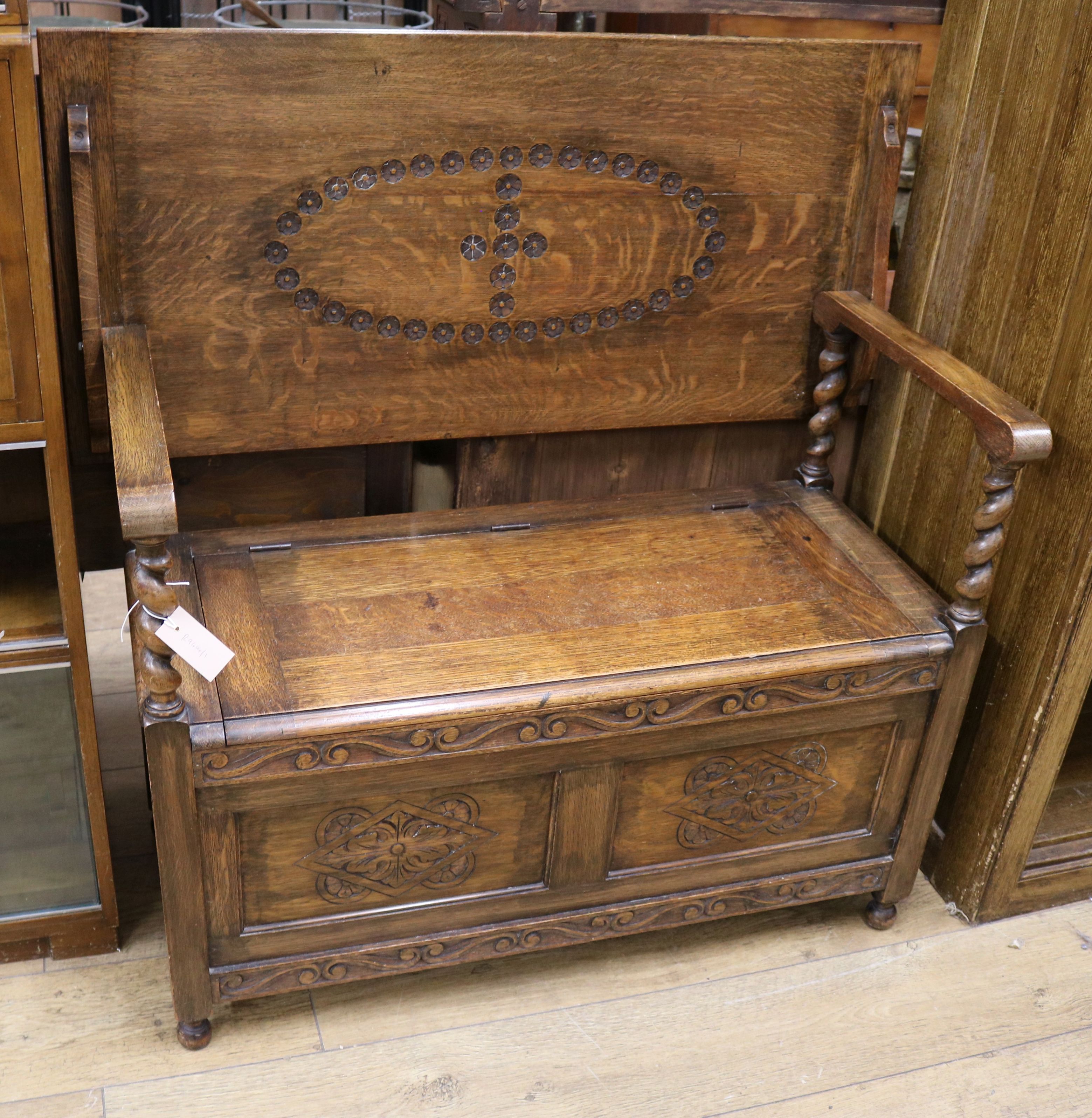 A 1920's oak monk's bench W.106cm