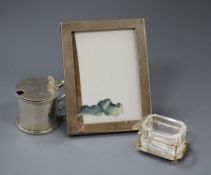 A Victorian silver mustard pot, London, 1862, a George V silver mounted photograph frame and a Hukin