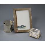 A Victorian silver mustard pot, London, 1862, a George V silver mounted photograph frame and a Hukin