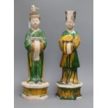 A pair of Chinese sancai tall pottery figures of attendants