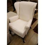 A modern upholstered wing armchair