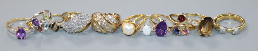 Eleven assorted 9ct gold gem set rings, including diamond, amethyst and opal, gross 39 grams.