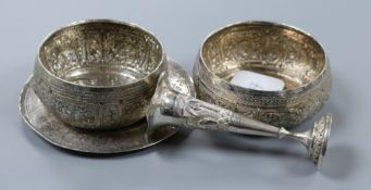 A Persian white metal saucer dish, two Eastern white metal bowls and a white metal spill vase.