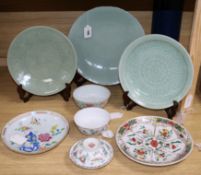 Three Chinese celadon-glazed dishes with incised decoration and hardwood stands largest diameter