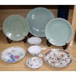 Three Chinese celadon-glazed dishes with incised decoration and hardwood stands largest diameter