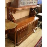 A Victorian mahogany buffet, with panel and shelf above, on openwork S scroll supports, with three