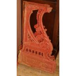 A pair of Victorian Athenian style red painted cast iron bench ends W.44cm