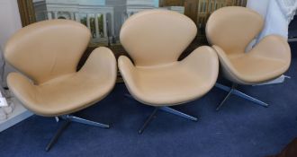 Three Arne Jacobsen designed swan chairs in tan leather