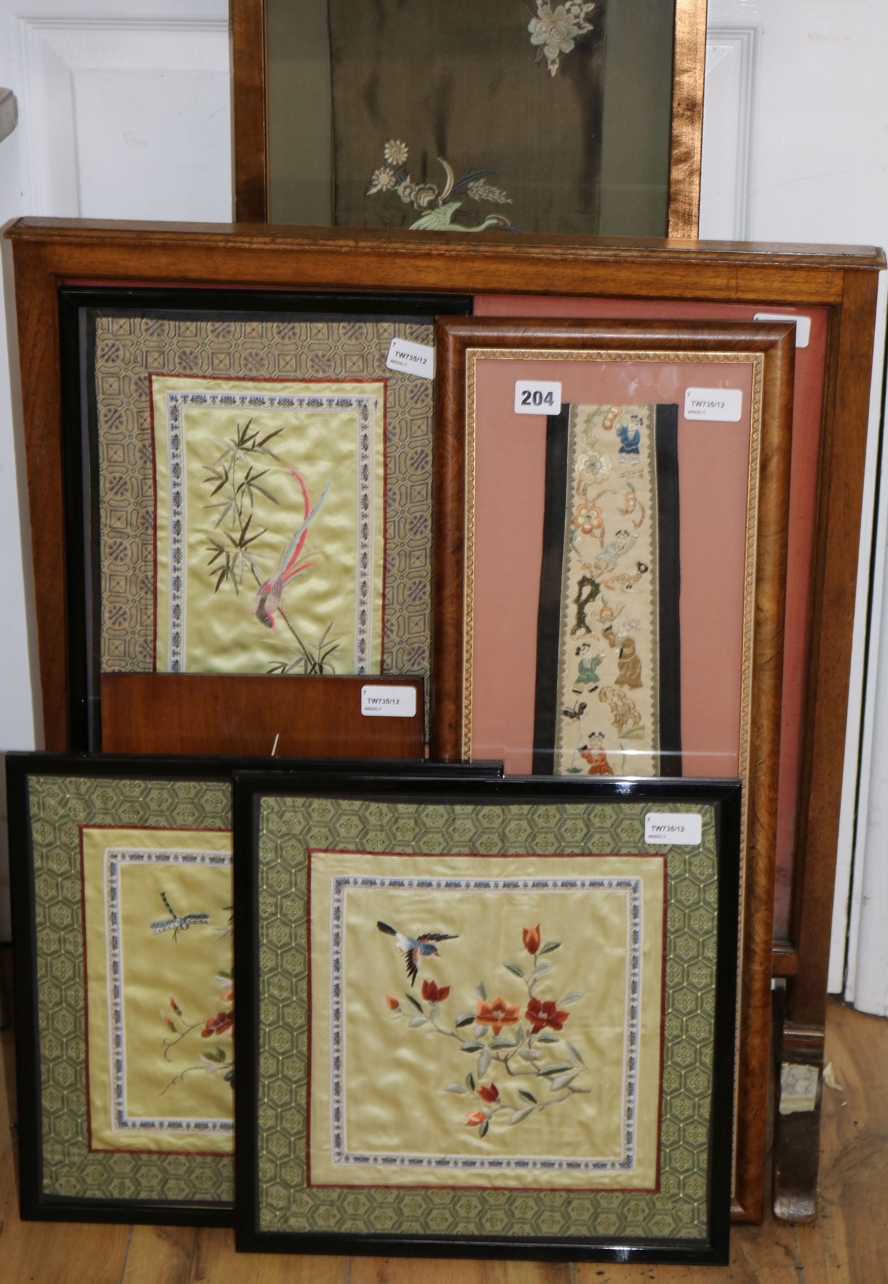 Six Chinese silk embroidered framed panels, comprising a firescreen inset with a stumpwork dragon, a