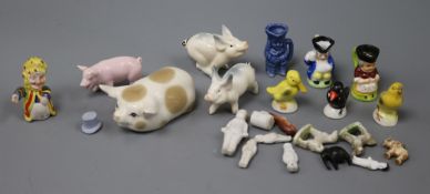 A collection of miniature dolls and ceramics and various ceramic pigs