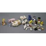 A collection of miniature dolls and ceramics and various ceramic pigs