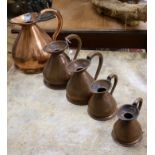 A set of graduated copper jugs
