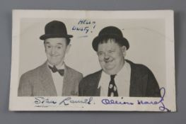 A Laurel and Hardy signed photograph, signed in blue ink and inscribed Hello Dusty!
