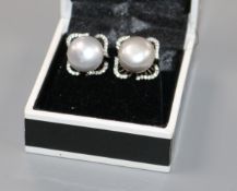 A pair of white metal, cultured pearl and diamond set ear studs.