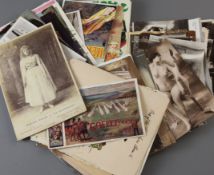 A group of Edwardian and later postcards and photos, including seaside views, saucy seaside