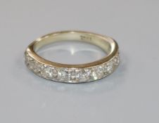 An 18ct. white gold and nine stone diamond half eternity ring, size J.