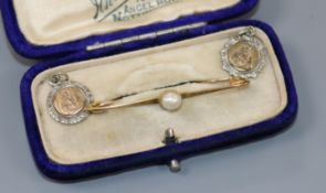 A late Victorian 9ct gold pearl set bar brooch with two medallion pendants.