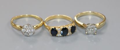 Two 18ct gold and gem set rings including diamond cluster and a 9ct gold and diamond cluster ring.