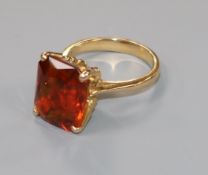 A yellow metal mounted single stone emerald cut citrine dress ring, size H.