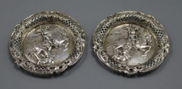 A pair of late Victorian embossed silver nut dishes, depicting St George & the Dragon, London, 1896,
