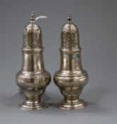 Two similar George II/III silver pepperettes/casters, John Delmester, London, 1758 and I.D London,
