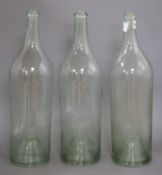 Three mid 20th century glass bottles height 45cm