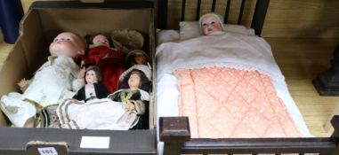 A doll's bed and a collection of bisque-headed dolls and others