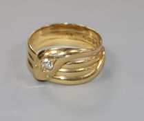 An early 20th century 18ct gold and diamond set serpent ring, size W.
