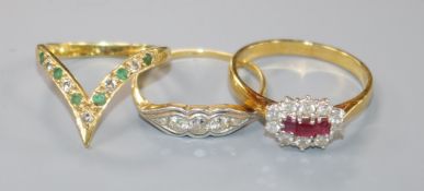 An 18ct gold, ruby and diamond cluster ring and two other 18ct gold rings, including a three-stone