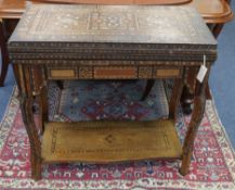 A Syrian mother of pearl inlaid games table W.82cm