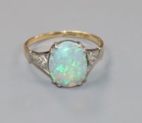 A 1920's 18ct gold, black opal ring with diamond set shoulders, (opal chipped), size L.