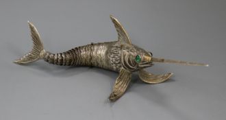 A Spanish white metal articulated free-standing model of a swordfish with green cabochon stone eyes,