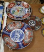 An Imari dish and two plates largest width 39cm