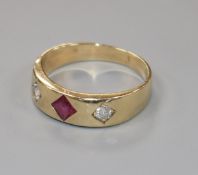 A yellow metal and gypsy set ruby and diamond three stone ring, size W.