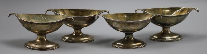 A set of four George III provincial silver two handled boat shaped pedestal salts, John Langlands,