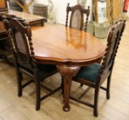 An oval burr walnut dining table and three chairs W.135cm