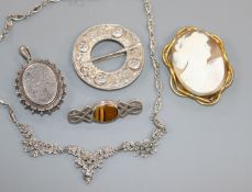 An engraved silver locket, a cameo, a tiger's eye quartz brooch, a Scottish silver Celtic knot