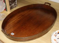 A mahogany brass bound oval tray