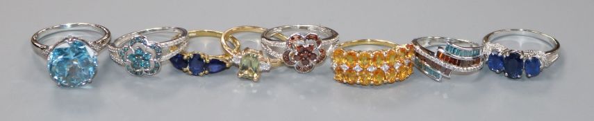 Eight assorted modern 9ct gold and gem set rings, gross 22 grams.