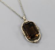 A large white metal framed facet cut single stone smoky quartz pendant, together with a silver
