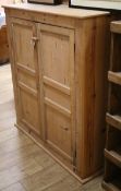 A Victorian pine two door cupboard W.111cm